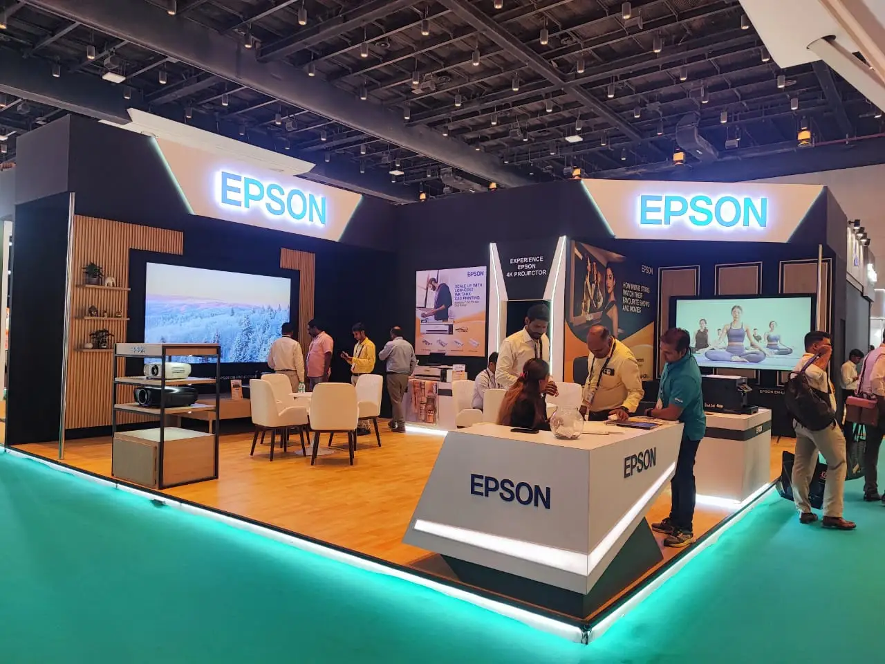 modern exhibition booth showcasing interactive display systems, projector demonstrations, and experiential brand engagement zones